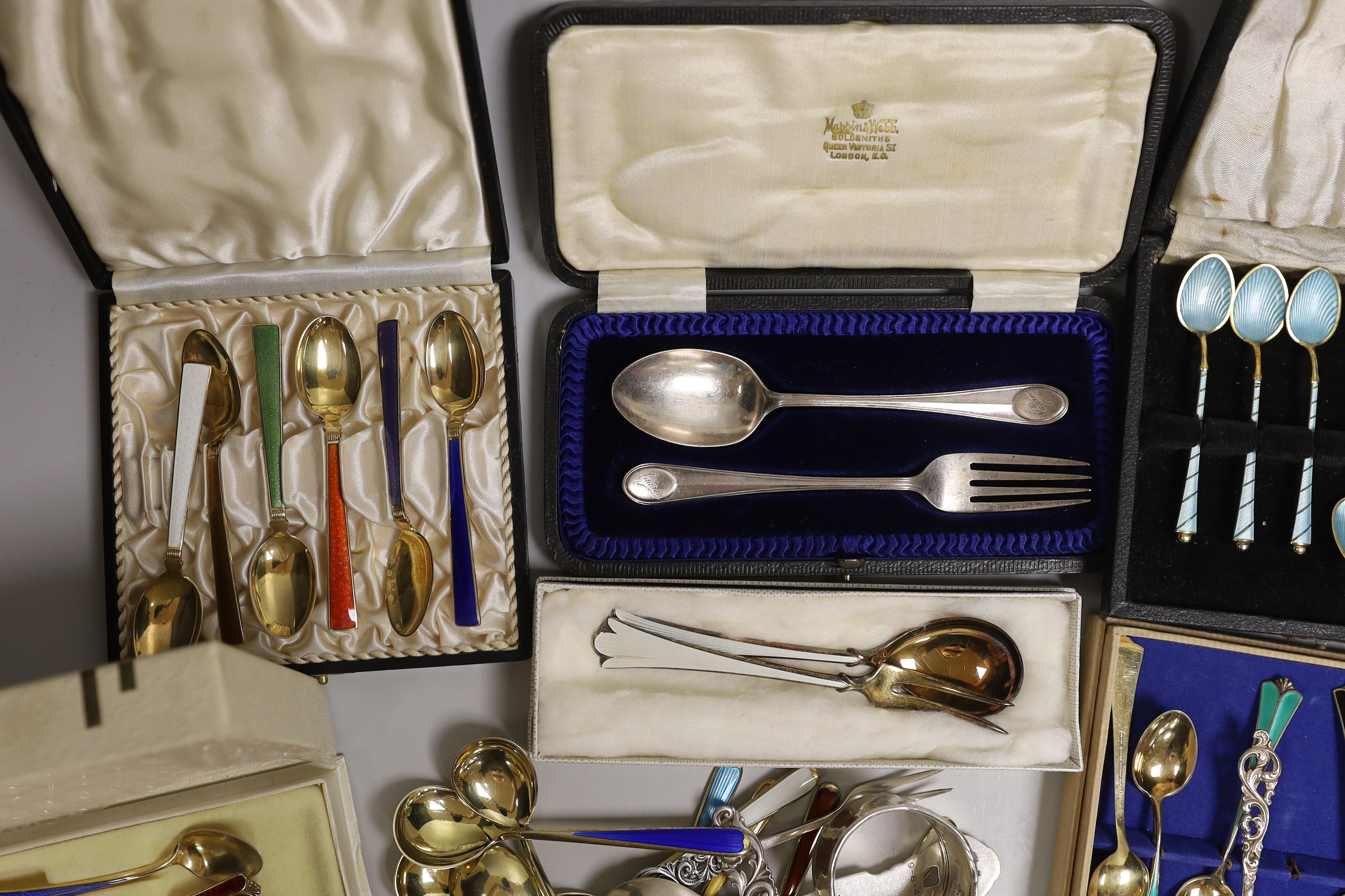 Two sets of eight Norwegian 925S and polychrome enamelled coffee spoons, by David Andersen, one other cased set of six Norwegian 925 and enamelled coffee spoons, a similar spoon and fork, a set of twelve Danish sterling